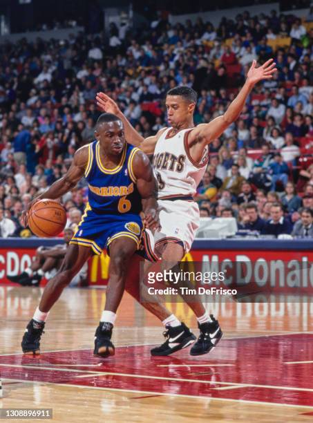 Avery Johnson, Point Guard for the Golden State Warriors dribbles the basketball around Mahmoud Abdul-Rauf of the Denver Nuggets during their NBA...