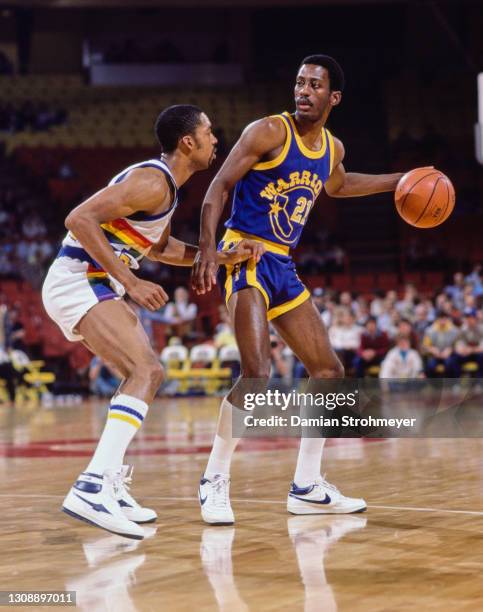 Eric Sleepy Floyd, Point Guard and Shooting Guard for the Golden State Warriors dribbles the basketball around Lafayette Fat Lever of the Denver...