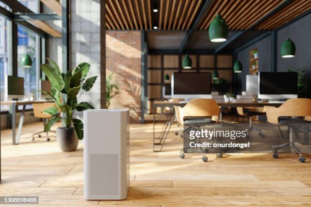air purifier in modern open plan office for fresh air, healthy life, cleaning and removing dust. - cool attitude stock pictures, royalty-free photos & images