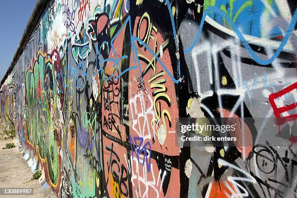 berlin wall covered with graffiti at the eastside gallery, berlin, germany, europe - catchwords stockfoto's en -beelden