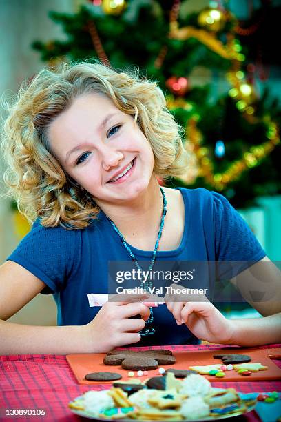 christmas baking, 13-year-old girl decorating christmas cookies - 12 year old blonde girl ストックフォトと画像