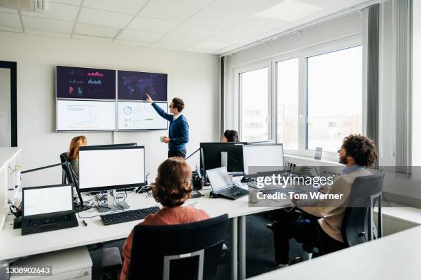 office with people reviewing data on monitors - analytics statistics stock pictures, royalty-free photos & images