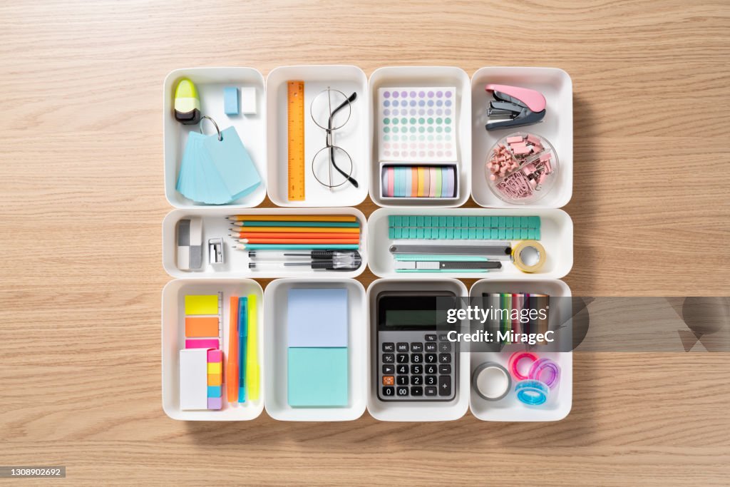 Neatly Organized Stationery in White Trays