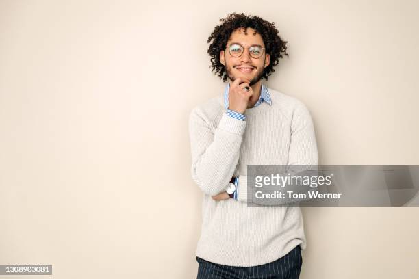 portrait of office employee with hand on his chin - studio portrait stock pictures, royalty-free photos & images