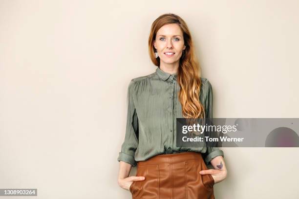 portrait of female business owner with long hair - green skirt stock pictures, royalty-free photos & images