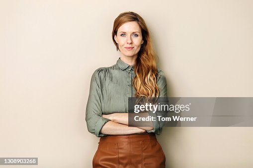 Businesswoman Smiling With Arms Folded Businesswoman Smiling With Arms Folded