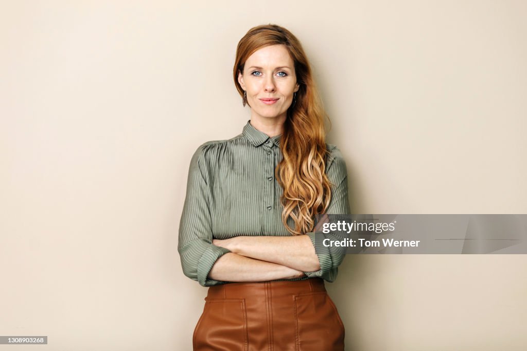 Businesswoman Smiling With Arms Folded