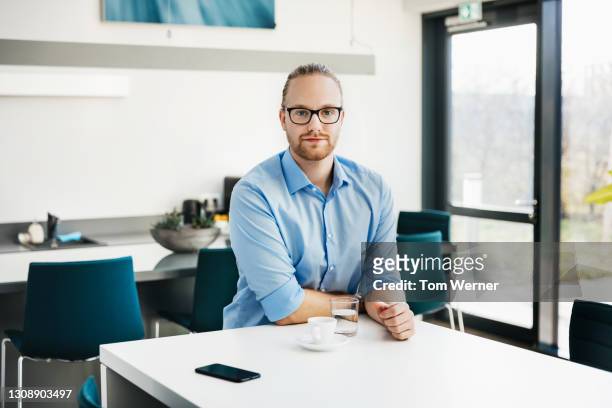 portrait of office worker sitting in cafetria with espresso - casual businessman glasses white shirt stock pictures, royalty-free photos & images