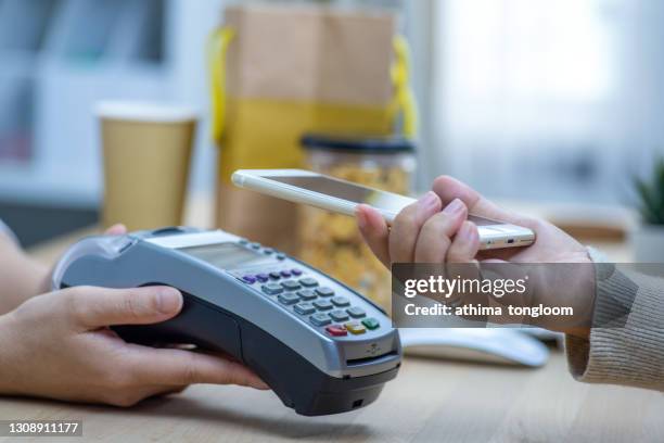 payment by mobile phone with qr code. - near field communication stock pictures, royalty-free photos & images