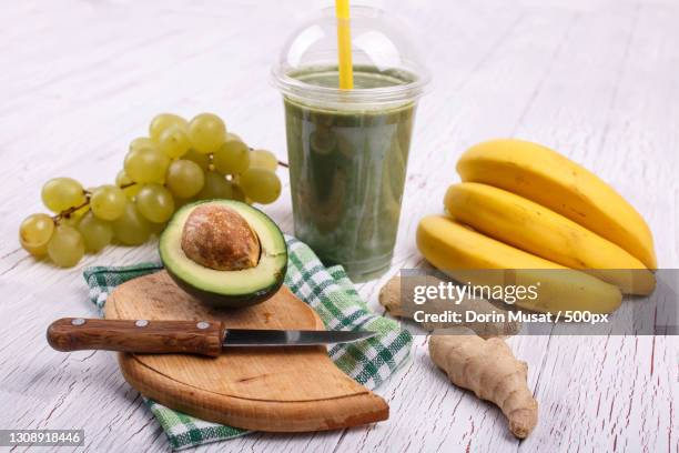 green smoothie with bananas,lime,grape and avocado lie on the ta - avocado smoothie stock pictures, royalty-free photos & images