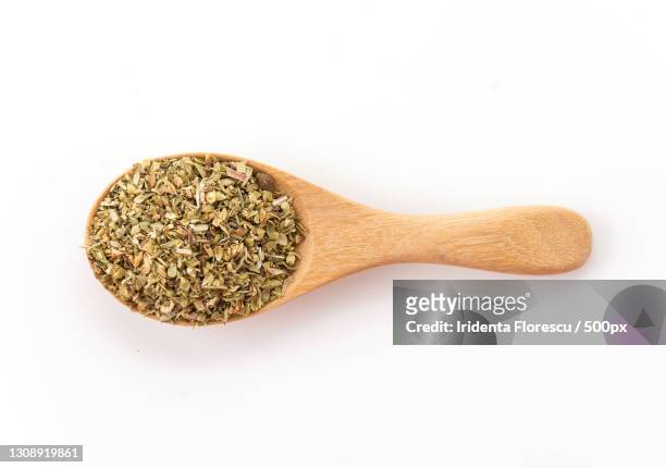 directly above shot of spices in spoon on table - origano foto e immagini stock