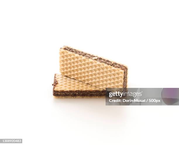 close-up of bread against white background - wafeltje stockfoto's en -beelden