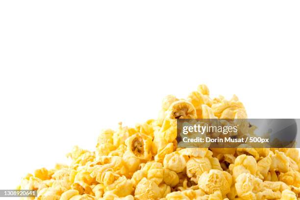 close-up of popcorn against white background - caramel corn stock pictures, royalty-free photos & images