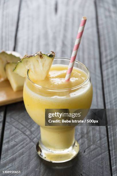 close-up of drink on table - yellow smoothie stock pictures, royalty-free photos & images