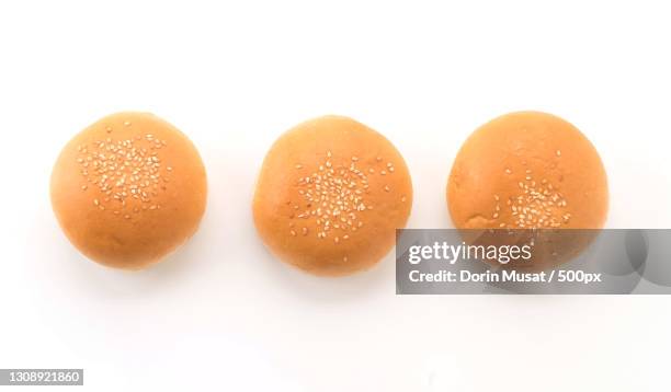 close-up of breads against white background - bun fotografías e imágenes de stock