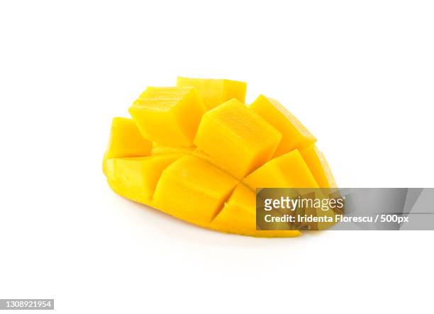 close-up of mango against white background - mango piece stock-fotos und bilder