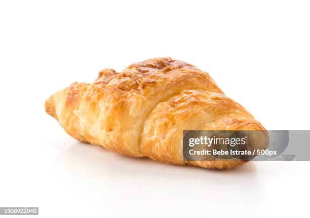 close-up of croissant on white background - croissant white background stockfoto's en -beelden