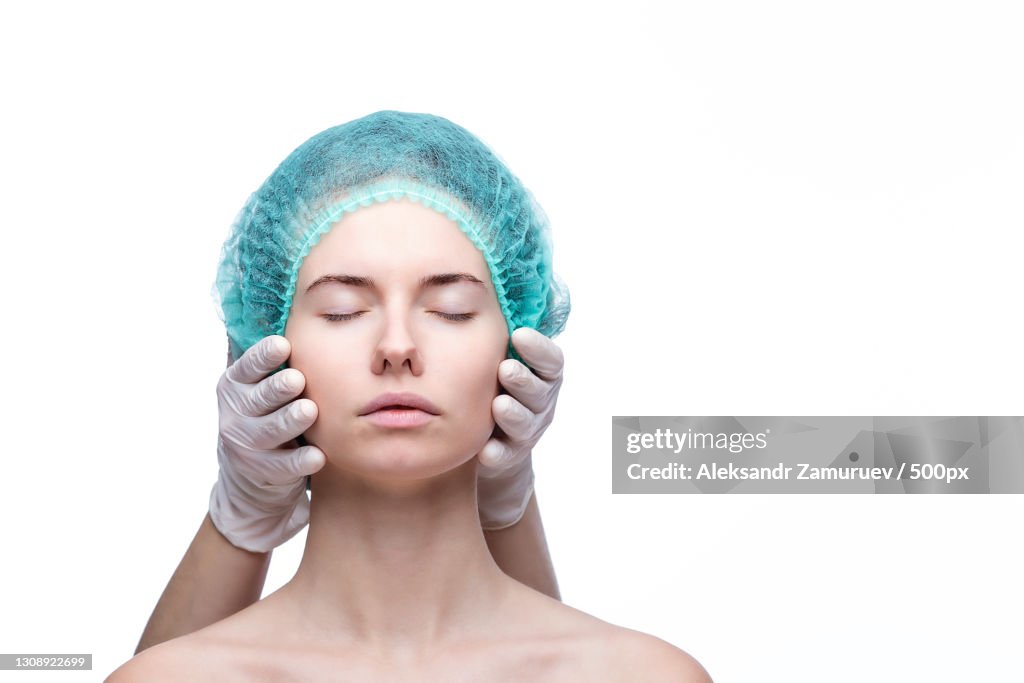 Close-up of young woman with eyes closed against white background