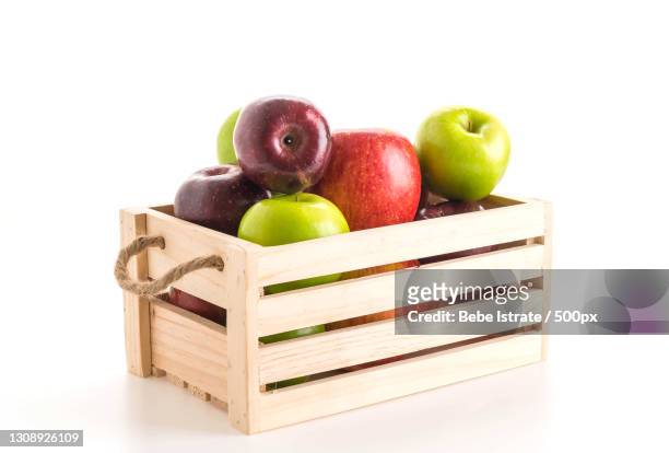 close-up of apples in crate against white background - apple fruit white background stock pictures, royalty-free photos & images