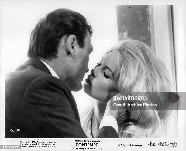 Jack Palance kissing Brigitte Bardot in a scene from the film 'Contempt', 1963.