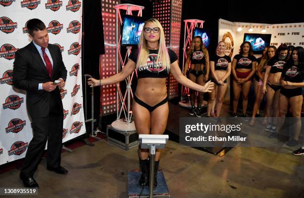 Ring announcer and host A.J. Kirsch checks the scale as Lauren "The Animal" Fogle weighs in for her match against Sarah "The Beast" Brooke during...