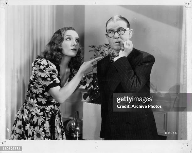 Unidentified woman pointing at Robert Woolsey in a scene from the film 'High Flyers', 1937.