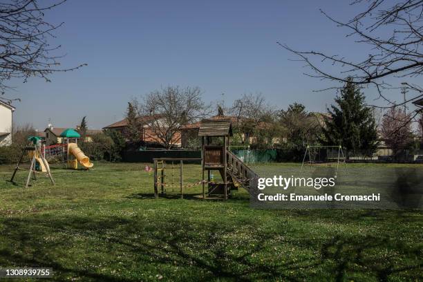 General view of a shuttered children's playground whose apparels are wrapped in red and white caution tape to keep children off on March 24, 2021 in...