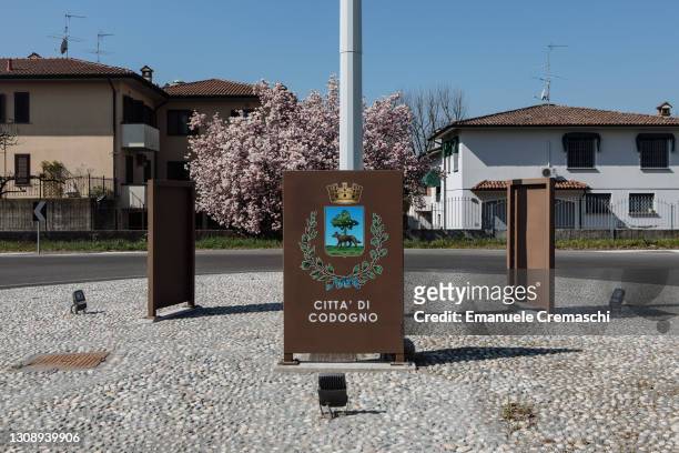 Sign depicting the coat of arms of the town of Codogno is pictured standing on a roundabout on March 24, 2021 in Codogno, Italy. Codogno was Italy's...