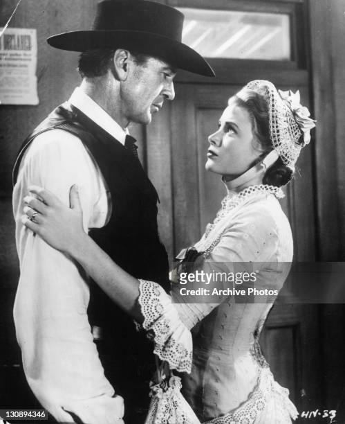 Gary Cooper is grabbed by Grace Kelly in a scene from the film 'High Noon', 1952.