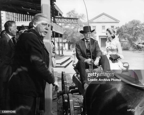 Gary Cooper and Grace Kelly in horse drawn carriage in a scene from the film 'High Noon', 1952.