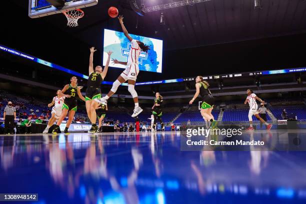 Maya Caldwell of the Georgia Lady Bulldogs drives to the basket over Erin Boley of the Oregon Ducks during the first half in the second round game of...