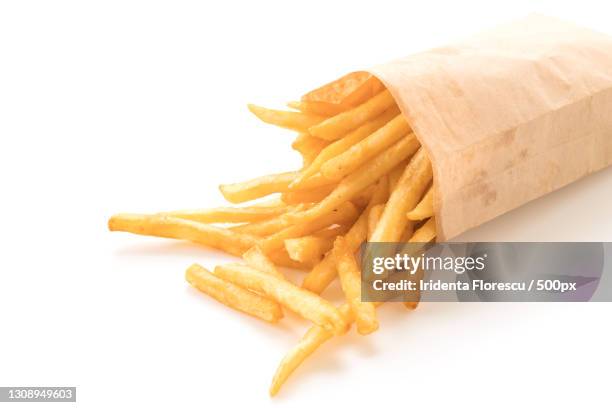 close-up of french fries against white background - french fries white background stock-fotos und bilder