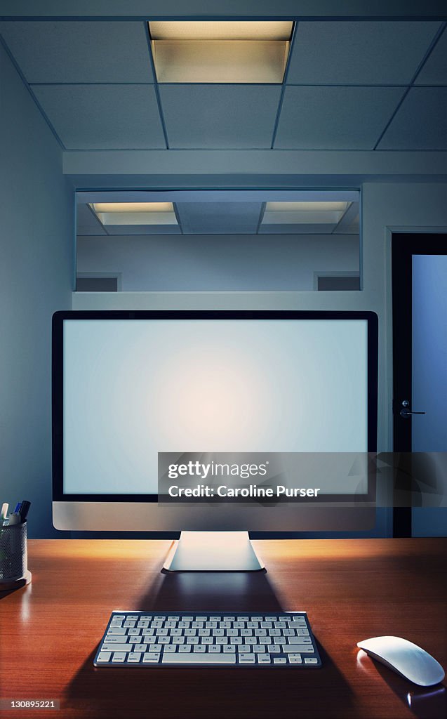 Blank computer screen on a desk in an office