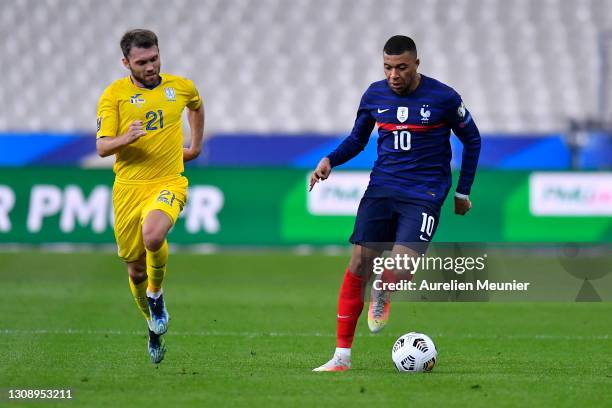 Kylian Mbappe of France runs with the ball whilst under pressure from Oleksandr Karavayev of Ukraine during the FIFA World Cup 2022 Qatar qualifying...