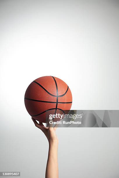 hands holding a basketball,hands close-up - basketbal bal stockfoto's en -beelden