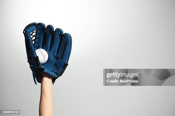 hand holding a baseball glove and ball - catchers mitt stock pictures, royalty-free photos & images