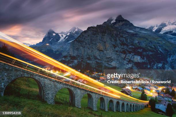 funicular light trails on mountain ridge, murren, switzerland - lauterbrunnen stock pictures, royalty-free photos & images
