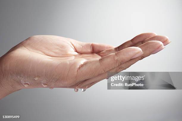 water drop on the hand, close-up - washing hands close up stock pictures, royalty-free photos & images