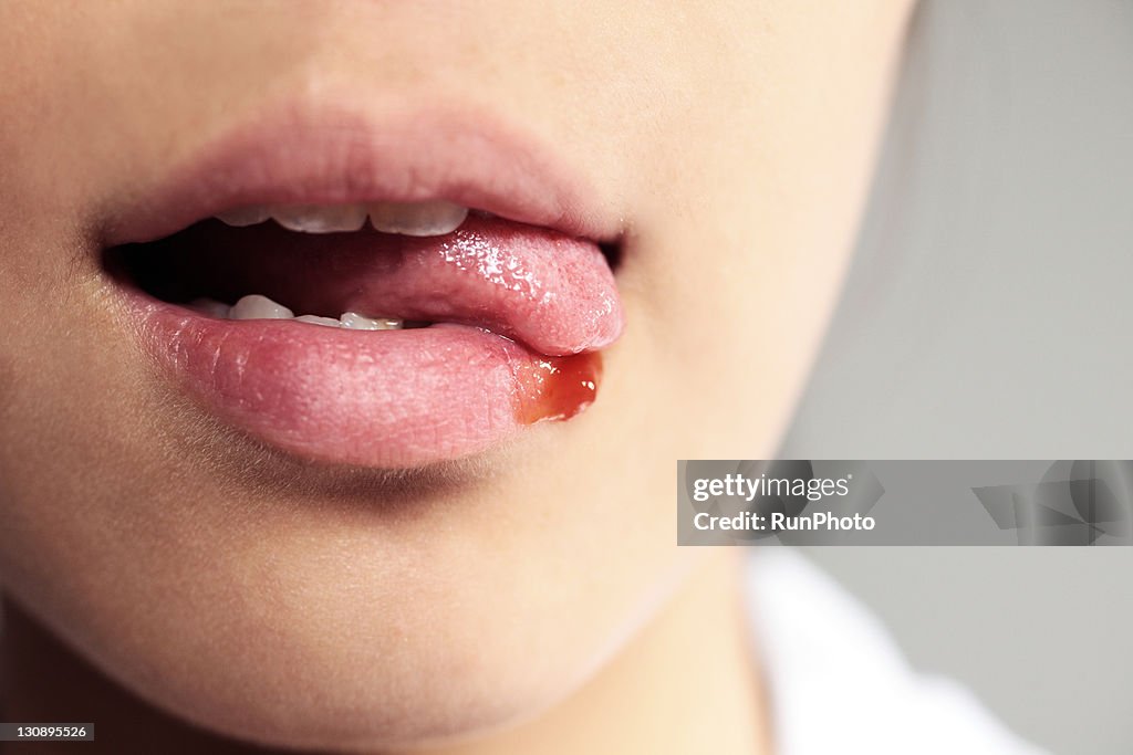 Woman with ketchup on lip