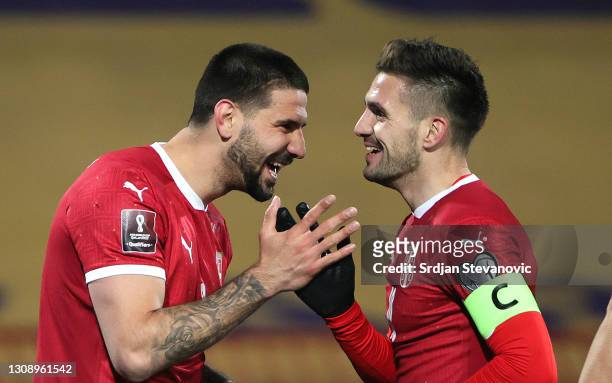 Aleksandar Mitrovic of Serbia celebrates after scoring his sides third goal with teammate Dusan Tadic during the FIFA World Cup 2022 Qatar qualifying...