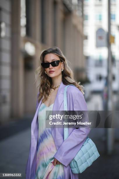 Mandy Bork wearing colorful Zara midi dress, lilac Boss coat, black Linda Farrow shades and baby blue Bottega Veneta leather bag on March 22, 2021 in...