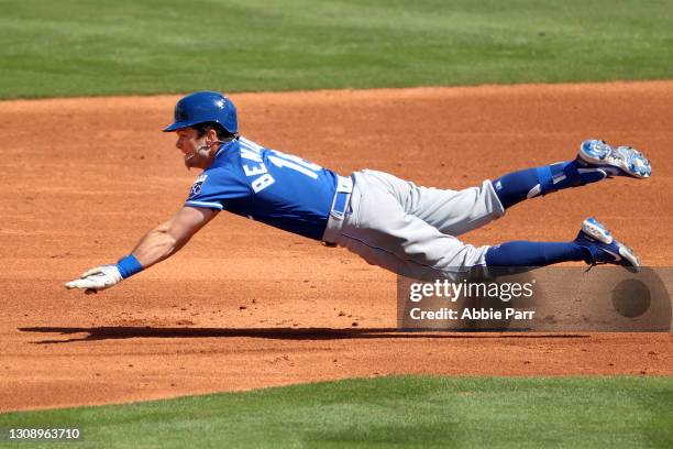 Andrew Benintendi of the Kansas City Royals dives to safely reach second base in the third inning against the Los Angeles Angels during the MLB...