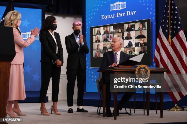 President Joe Biden looks at first lady Dr. Jill Biden and soccer stars Margaret Purce and Megan Rapinoe after signing a proclamation to mark Equal...