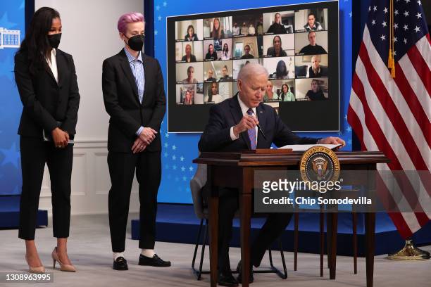 President Joe Biden signs a proclamation to mark Equal Pay Day with soccer superstars Margaret Purce and Megan Rapinoe, with members of the U.S....