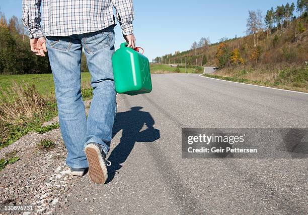 walking along countryside road with petrol can - gas can stock pictures, royalty-free photos & images