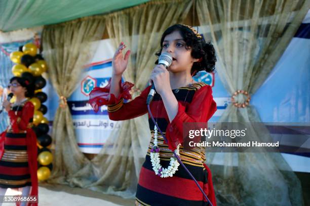 Primary school students speak to the audience during a celebration of the end of the academic year at their school on March 24, 2021 in Sana'a,...