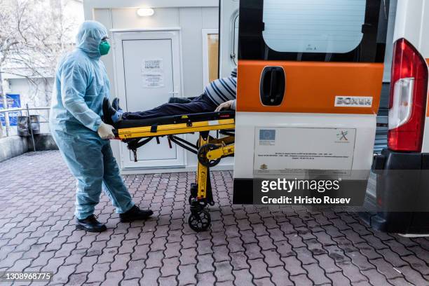 Paramedic Dimitar Stoyanov transfers a patient with coronavirus disease to a hospital on March 24, 2021 in Sofia, Bulgaria. Bulgaria reported 4,851...