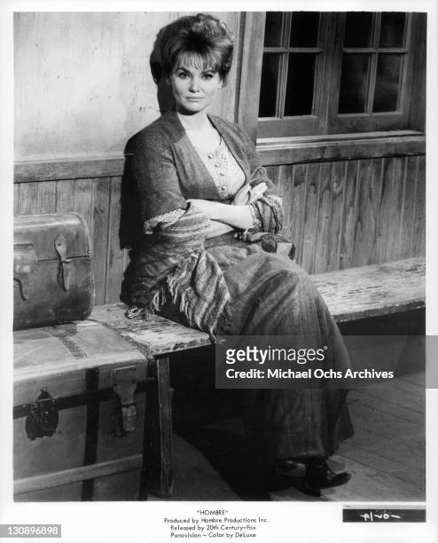Diane Cilento sit with arms folded in a scene from the film 'Hombre', 1967.