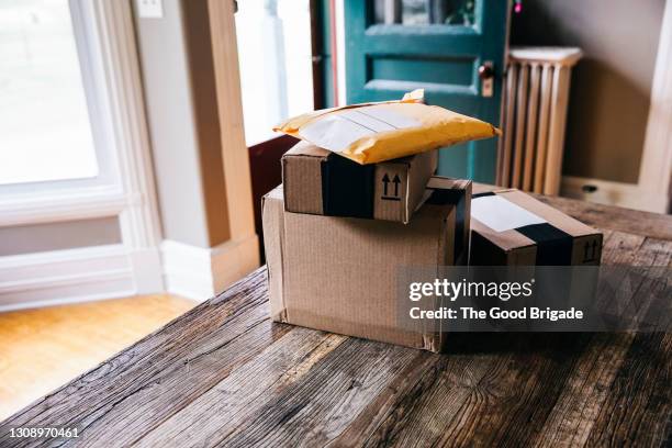 stack of packages on table at home - bulto fotografías e imágenes de stock