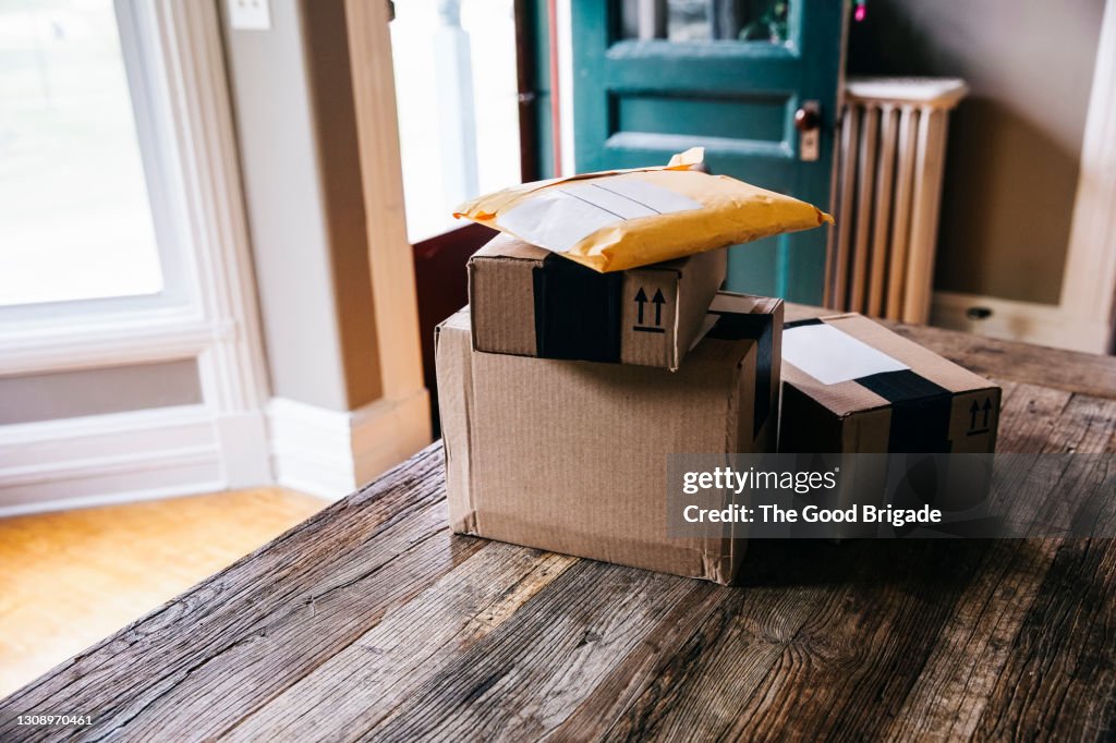 Stack of packages on table at home
